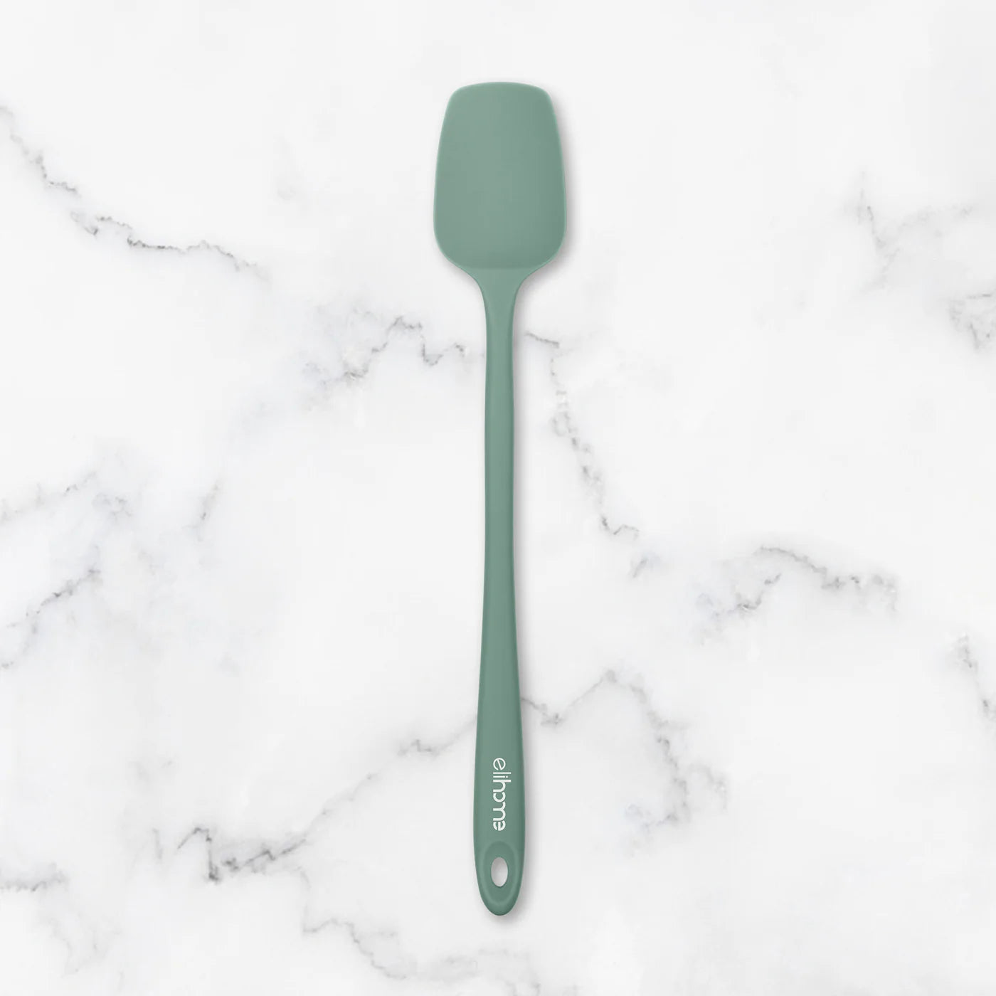 Green spatula on a marble surface
