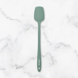Green spatula on a marble surface