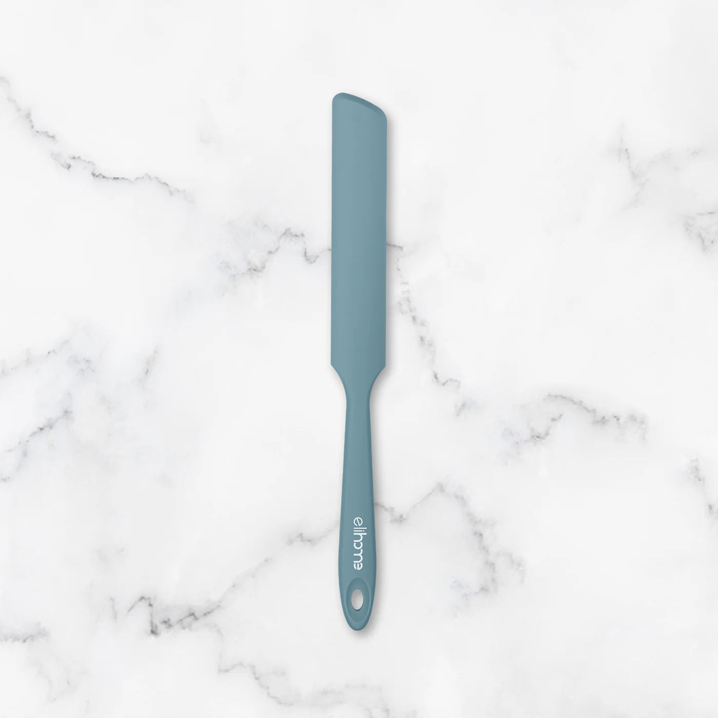 Blue spatula on a marble surface