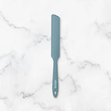 Blue spatula on a marble surface