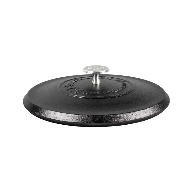 A black 12 inch cast iron lid with a handle in the center.