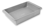 A stainless steel lasagna pan with a ribbed pattern on the bottom and a smooth, shiny surface.