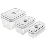 A set of three clear glass vacuum storage containers of different sizes with airtight lids.