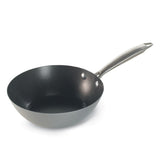 A black metal wok with a long handle.