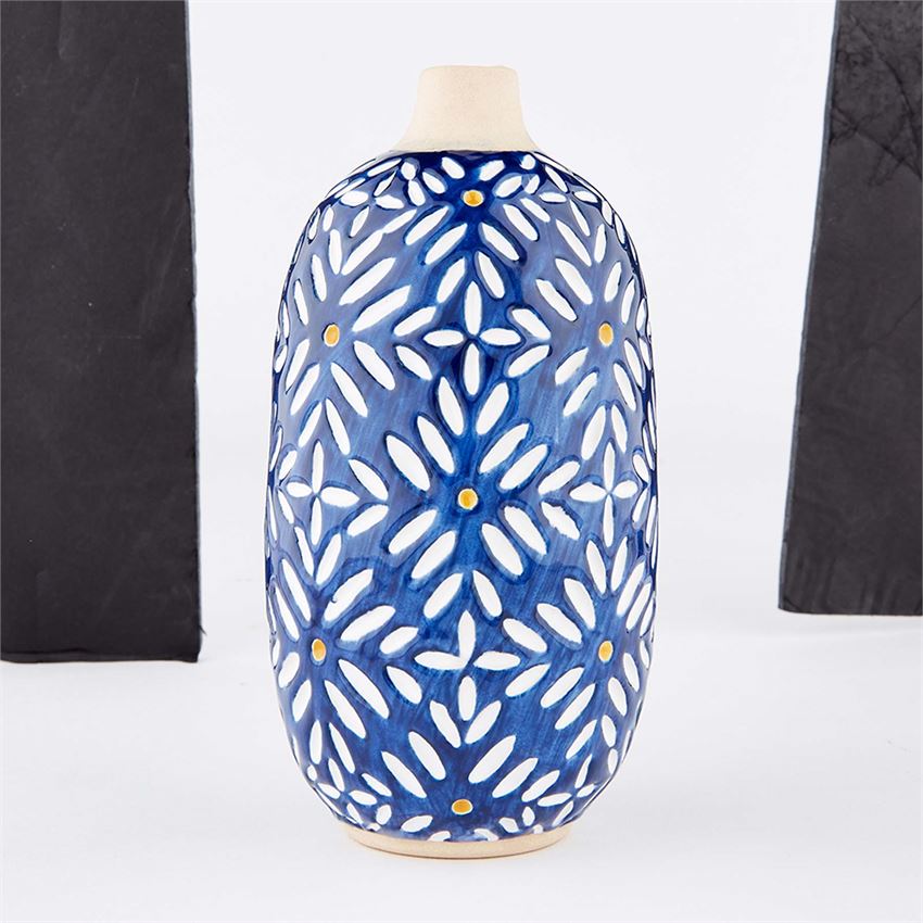 A medium-sized indigo blue ceramic vase with a geometric floral pattern and gold accents.