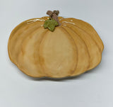 Ceramic pumpkin-shaped plate on a light gray background