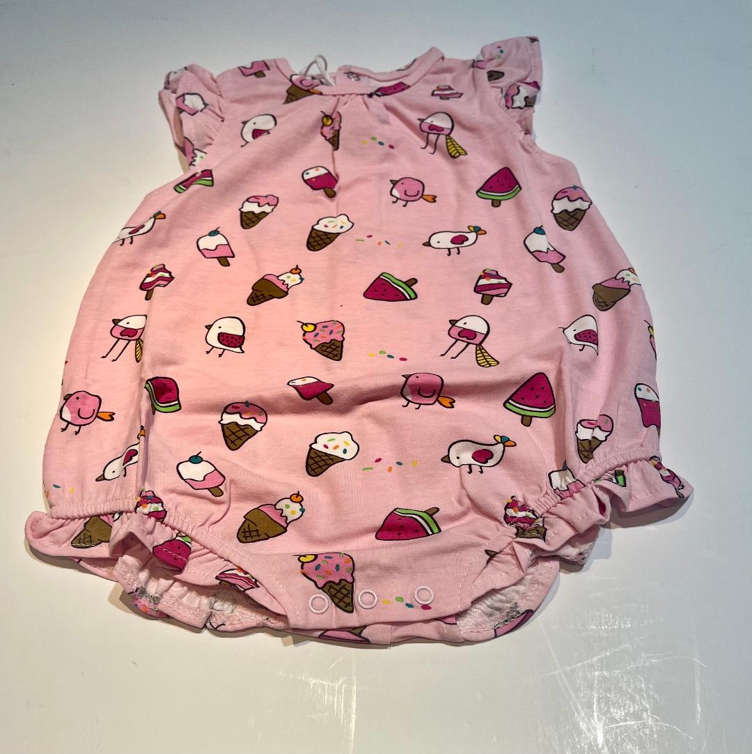 A sleeveless pink romper with a pattern of birds, cones, and other sweet treats.