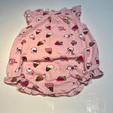 A sleeveless pink romper with a pattern of birds, cones, and other sweet treats.