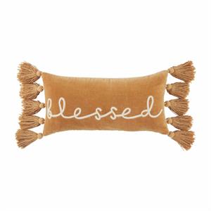 A rectangular velvet throw pillow with the word 'blessed' written on it, adorned with tassels on the sides.