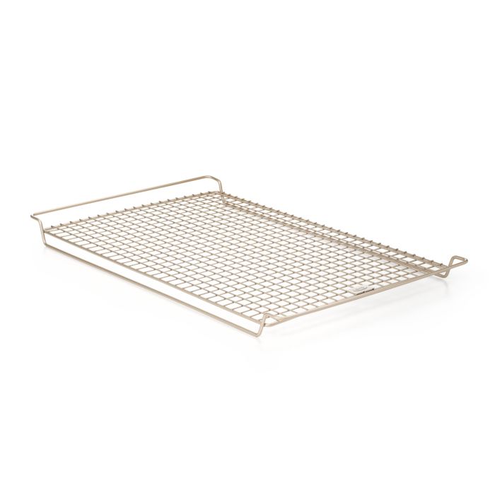 A nonstick cooling rack made of metal with a solid pattern and a handle on the side.