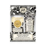 A gift set containing a foaming hand soap and a moisturizing hand cream with 'HONEY ALMOND' label, presented in a black and white patterned box with gold accents.