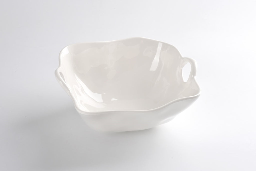 A large, white ceramic bowl with a smooth interior and an uneven exterior.