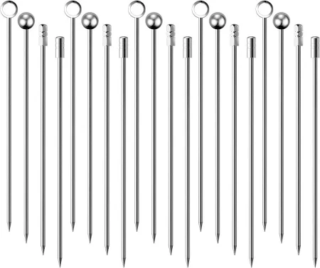 A set of 12 stainless steel cocktail picks of varying lengths, arranged in a line.
