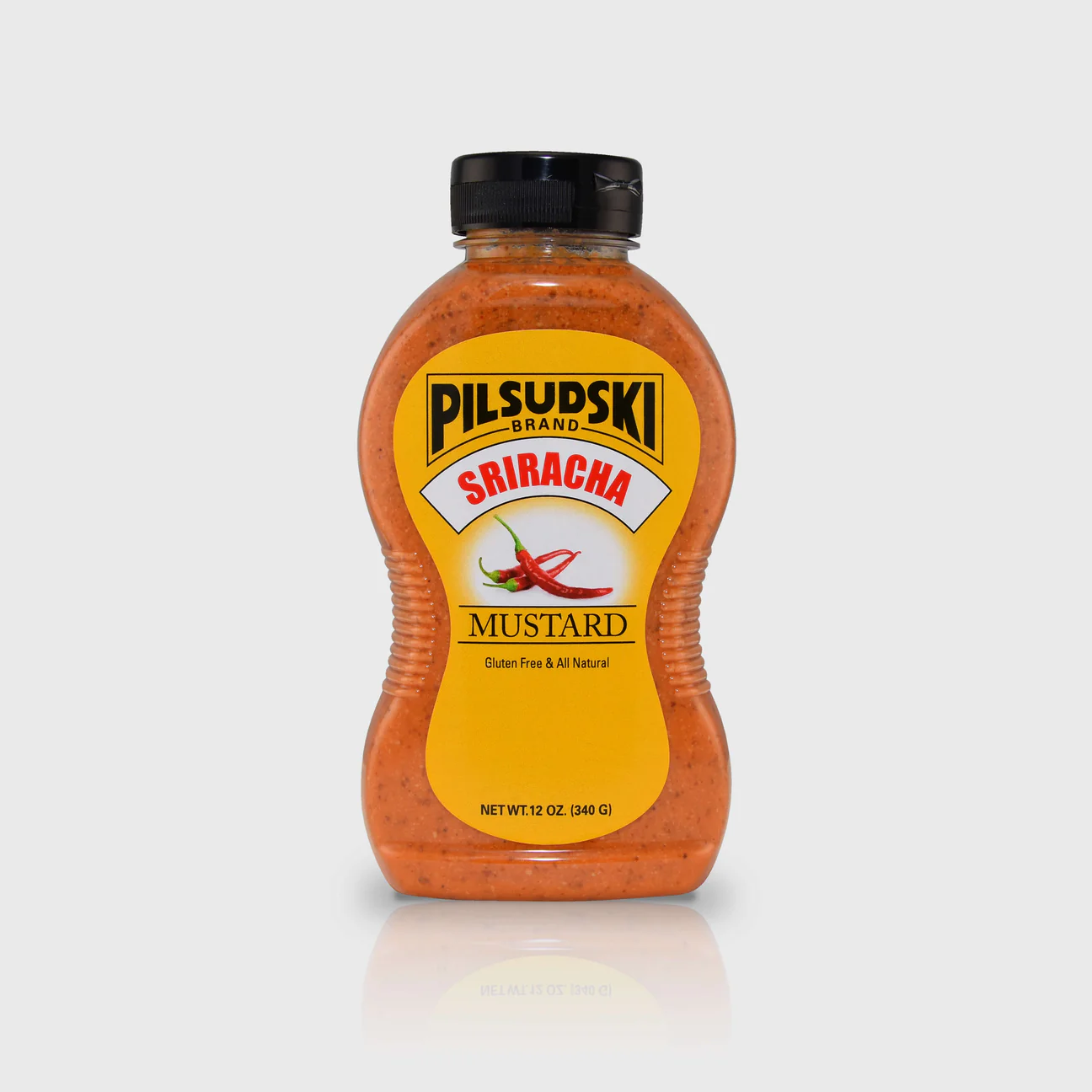 A bottle of Pilsudski Sriracha Mustard, gluten-free, with no preservatives, in a yellow and black label.