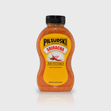 A bottle of Pilsudski Sriracha Mustard, gluten-free, with no preservatives, in a yellow and black label.