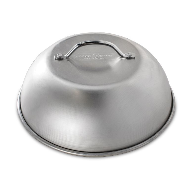 A silver domed grill lid with a handle on top.