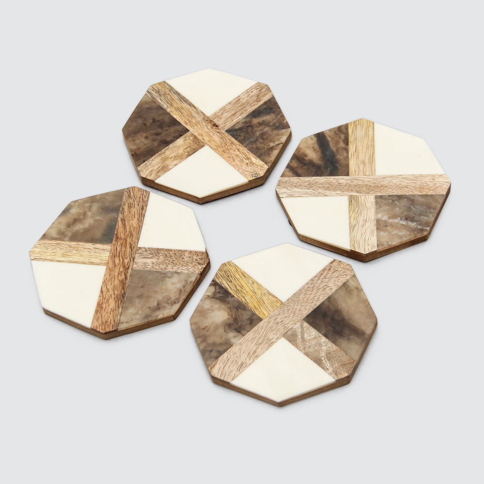 A set of four hexagonal coasters with a wood grain pattern and a mix of beige, brown, and white colors.