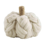 A beige chunky textured pumpkin-shaped sitter with a top handle.