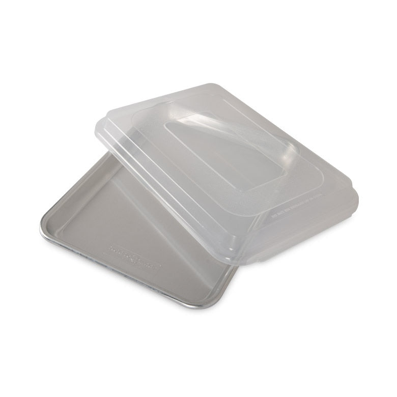 A clear plastic quarter sheet baking pan with a storage lid.