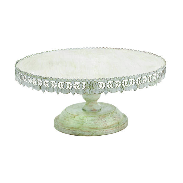 A white cake stand with floral lace detailing around the top edge, having a sturdy base and a pedestal support.