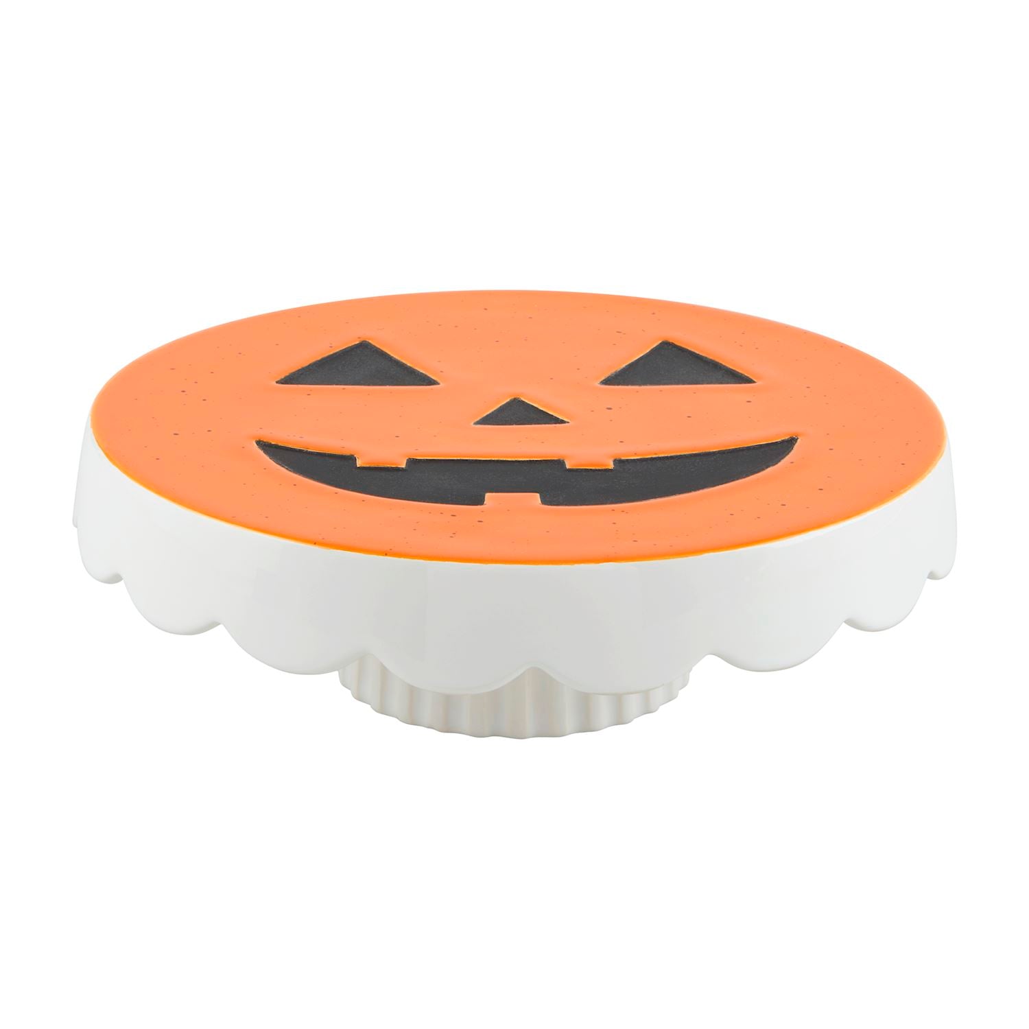 A white and orange pedestal with a pumpkin face design, likely intended as a decorative item for Halloween.