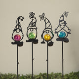 A collection of three solar lighted metal gnomes with colorful balls on top, designed for outdoor decor.