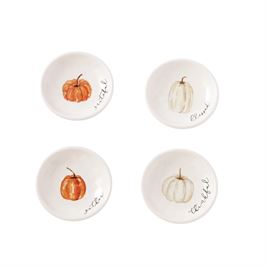 A set of four white ceramic dishes with a pumpkin design and different colors, displayed against a neutral background.