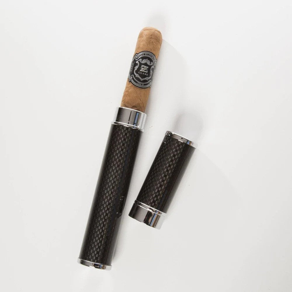A black and silver cigar tube with a cap, alongside a single cigar resting in the tube. The tube has a textured surface and a logo on the cap.
