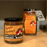 Jars of Captain Rodney's Temptation of Jezebel Sauce on a shelf, with the product's label visible.