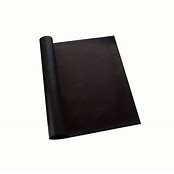 A rolled up black oven liner.