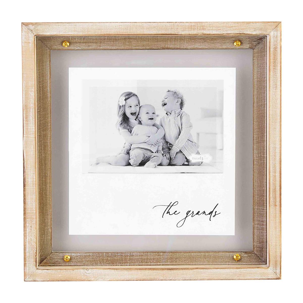 A wooden and brass frame picture frame, displaying a family photo with the word 'The Grange' written at the bottom.