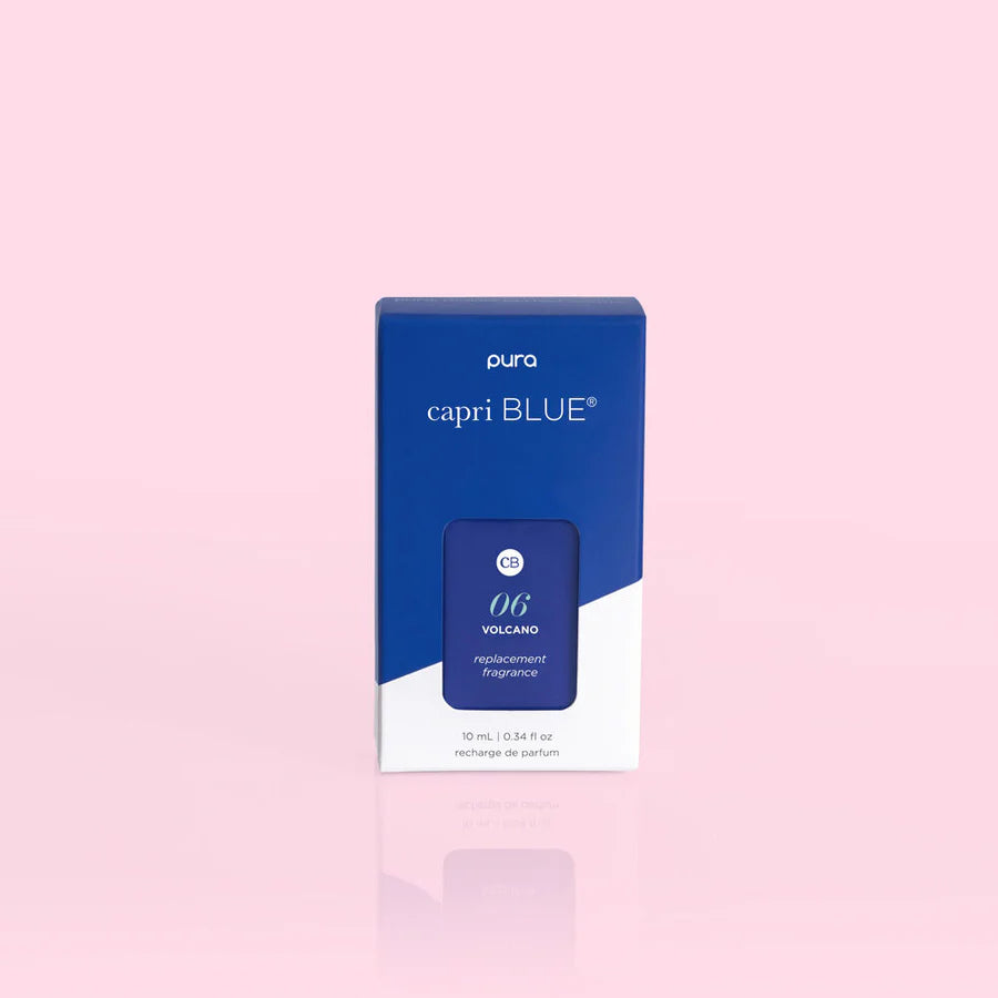 A box of Pura brand fragrance oil refill, with the name 'capri BLUE' visible on the packaging.