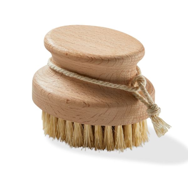 A beige round scrubber brush with natural fibers and a wooden top, bound by a rope.