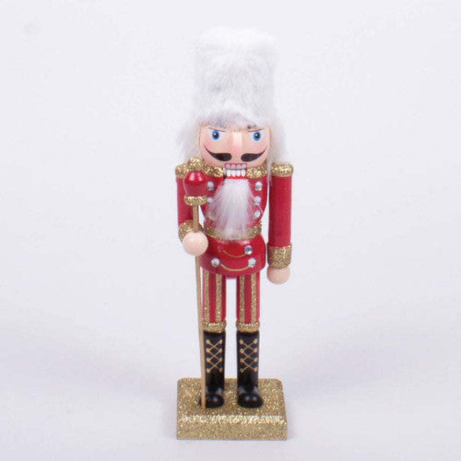 A 10-inch tall nutcracker with a decorative design, primarily in gold and white colors, dressed as a nutcracker character with a mustache.
