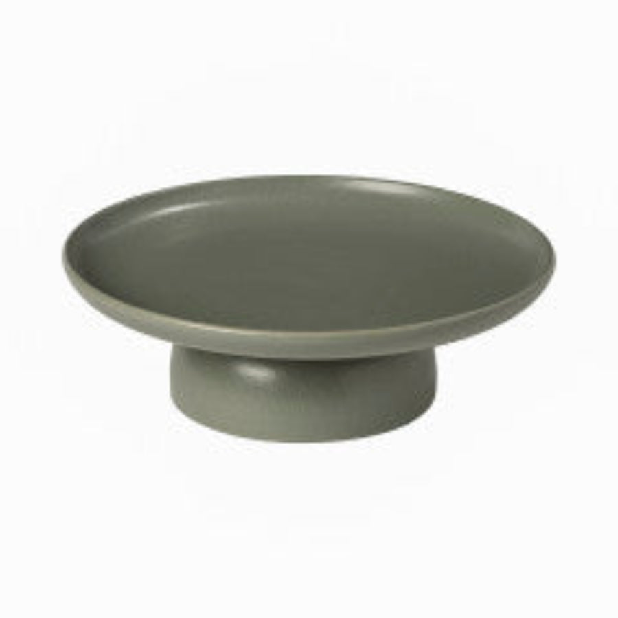 A white ceramic cake stand with a simple and elegant design.