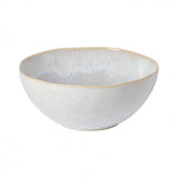 A ceramic serving bowl with a pale blue interior and a speckled pattern with a golden rim on the exterior.