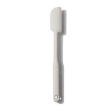 A gray silicone spatula with a stainless steel handle, isolated on a white background.