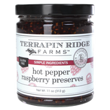 A jar of Terrapin Ridge Hot Pepper Raspberry Preserves with a label indicating the product is gluten-free, vegan, oil-free, and dairy-free.
