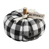 A decorative pumpkin sitter with a black and white buffalo check pattern and a tag that says 'SO SPOOKY'.