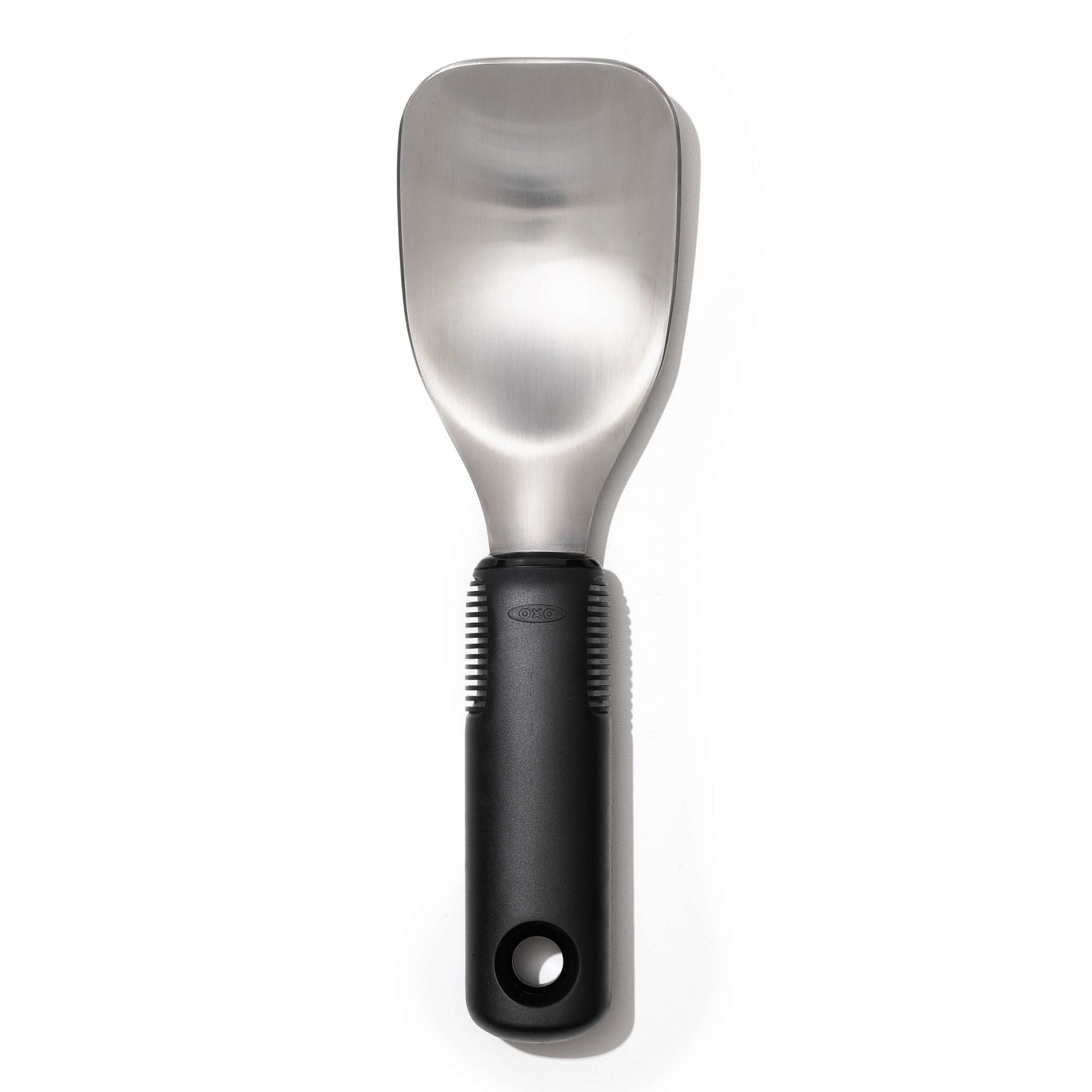 A stainless steel ice cream spade with a black handle, designed with a flat back and rounded edges for scooping ice cream.