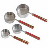 A set of four stainless steel measuring cups with red and green handles.