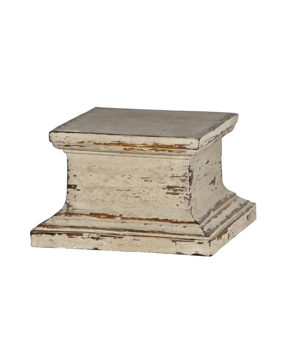 A beige and brown lamp pedestal with a distressed finish.