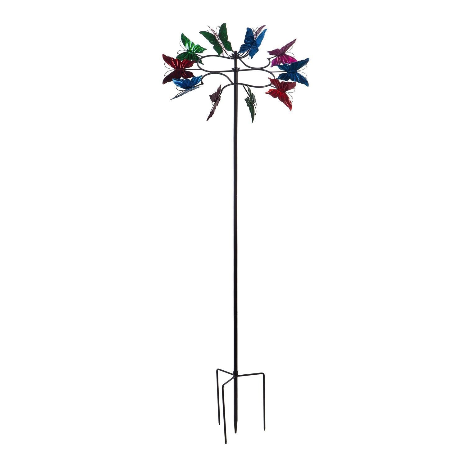 A butterfly wind spinner with a metal structure and multicolored plastic butterflies attached to the top, mounted on a metal pole.