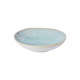 A ceramic pasta bowl with a blue exterior and beige interior.
