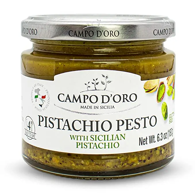 A jar of CAMPO D'ORO Pistachio Pesto with Sicilian Pistachio. The label shows the brand name, product name, and net weight of the pesto.