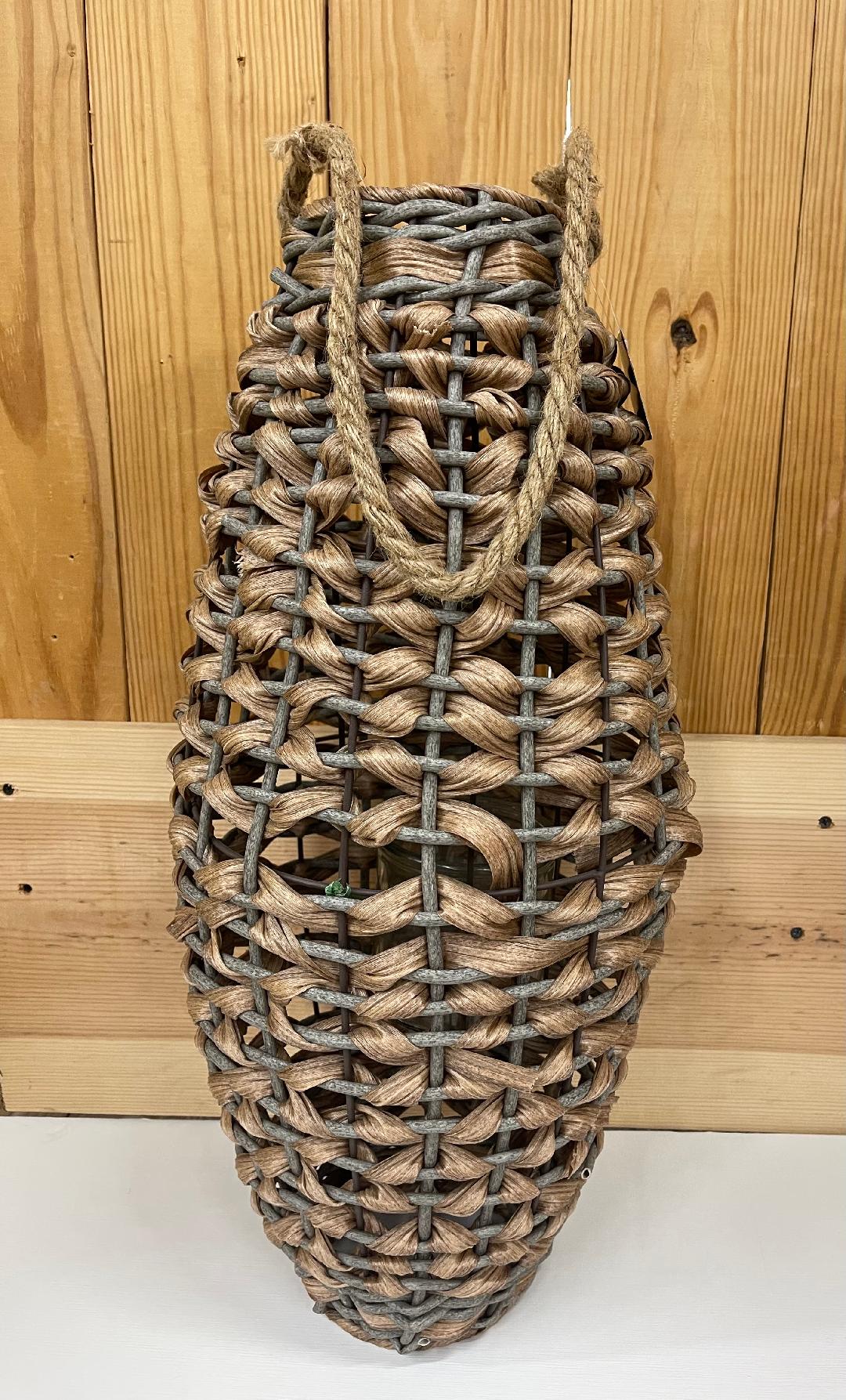 A beige-colored, large cone-shaped wind lantern made of woven material, displayed against a wooden background.