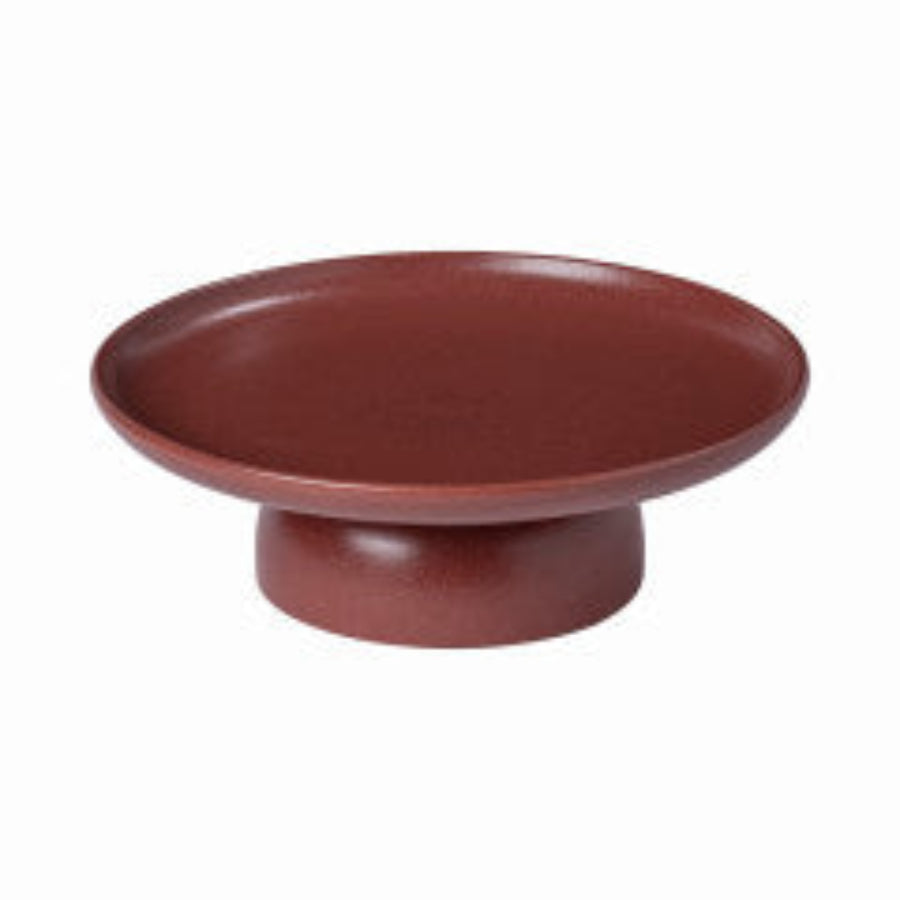 A white ceramic cake stand with a simple and elegant design.