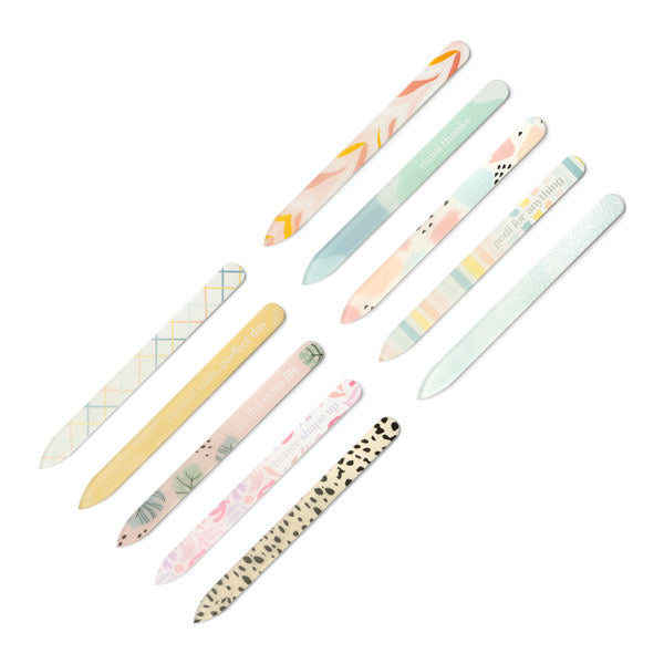 A collection of glass nail files with various decorative patterns.