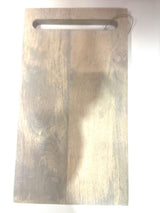 A rectangular acacia wood serving board with a rustic finish and a metal handle.