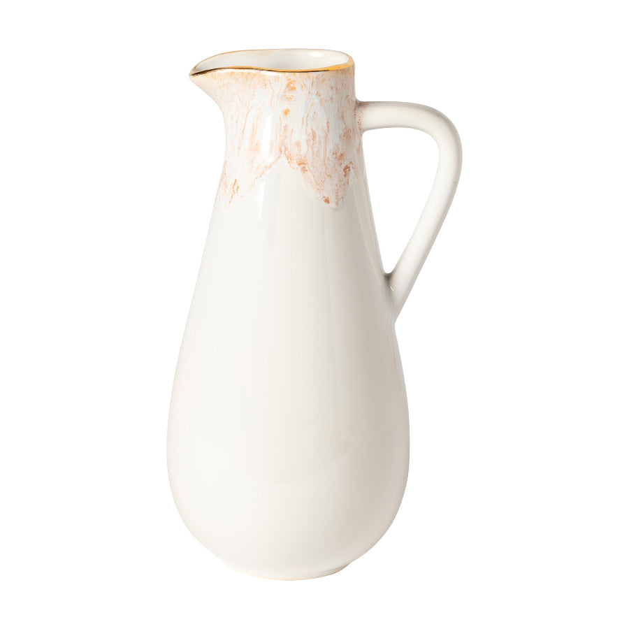 A white ceramic pitcher with a speckled pattern and a handle on the side.